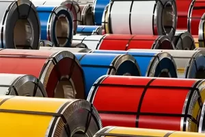 Color-coated PPGI steel coils stacked in warehouse for export, showing galvanized steel coils used in marine transport and tropical storage to prevent white rust and coating peeling-banner