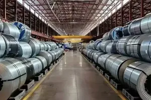Large rows of high carbon steel coils stored in an industrial warehouse, showcasing strength and wear-resistant materials for manufacturing.
