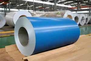 Prepainted galvanized steel coils (PPGI) in a warehouse, ready to be processed into roofing sheets and wall cladding for construction projects.